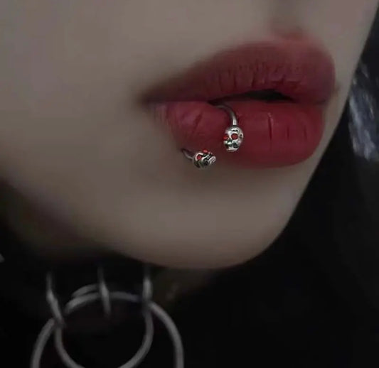 16G Silver Skull Lip Labret Ring for Lip Piercings with Red Eyes on Person's Lips Image